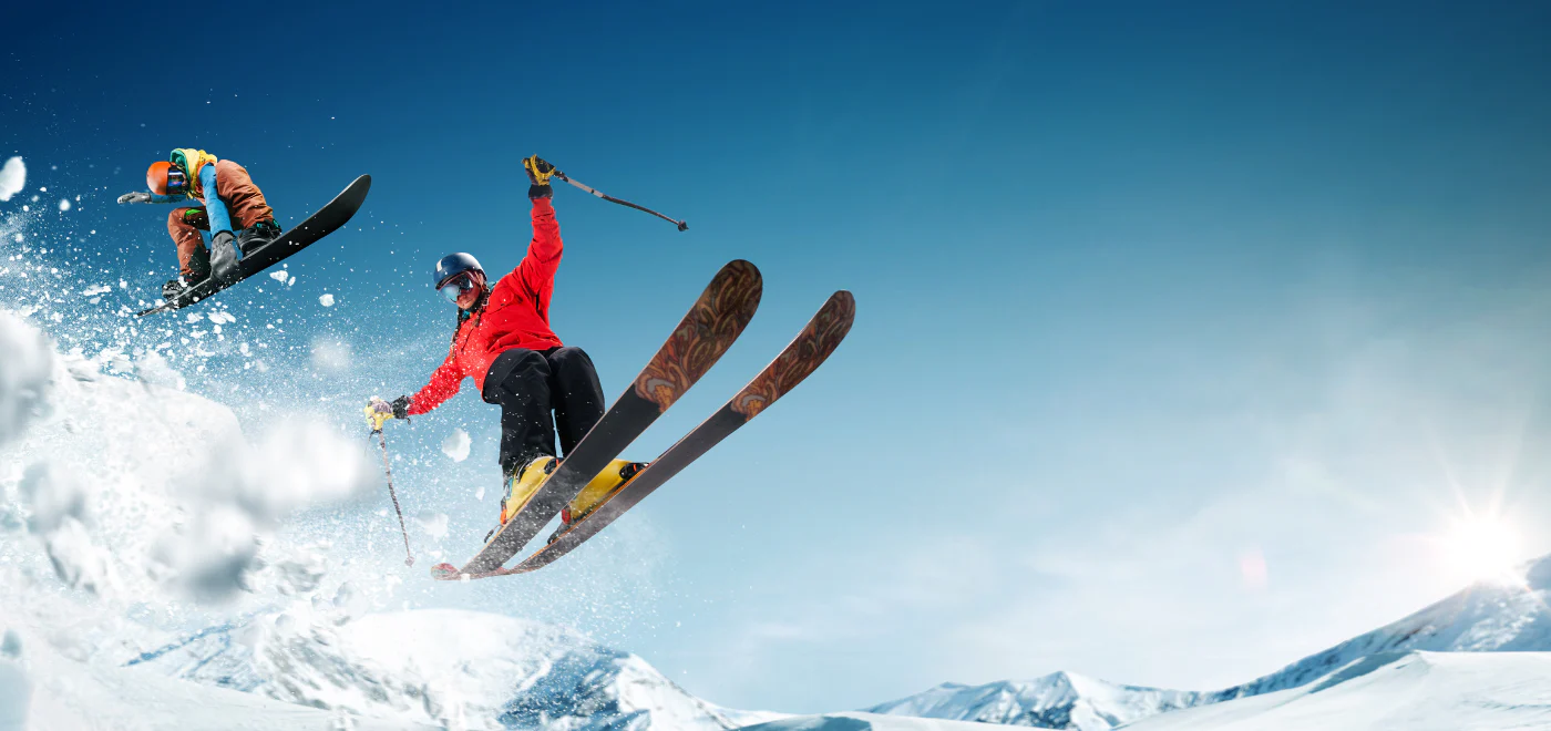 Skier and snowboarder on snowy slope